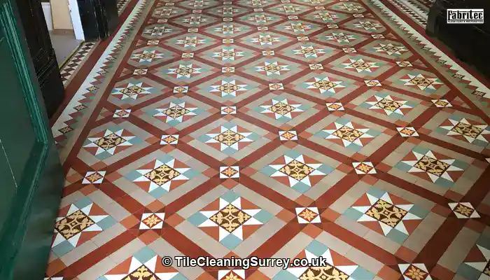 Original Victorian floor tiles in a Surrey hallway showing age, patina, and wear.