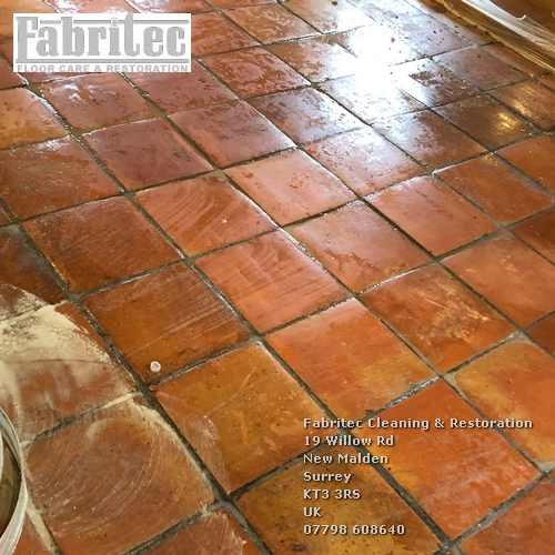 Scrubbing terracotta floors in Weybridge by Tile Cleaning Surrey